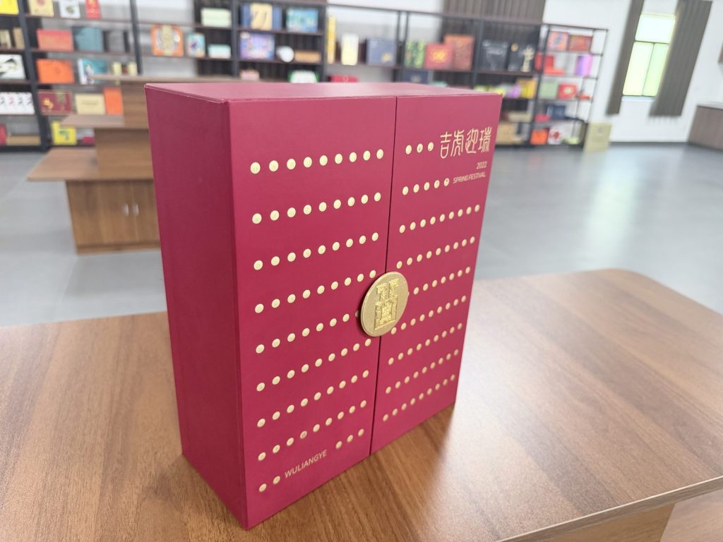 Elegant Maroon Gift Box With Gold Polka Dot Pattern And Circular Gold Clasp