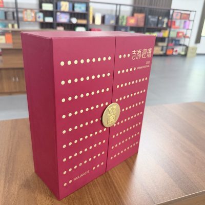 Elegant Maroon Gift Box With Gold Polka Dot Pattern And Circular Gold Clasp
