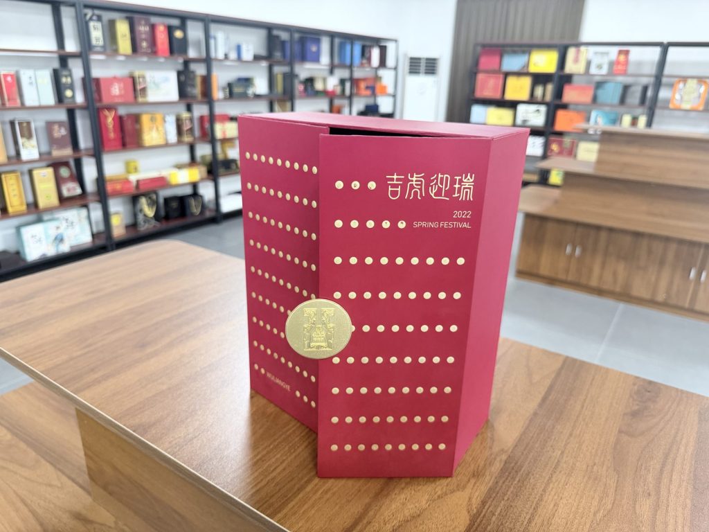 Elegant Maroon Gift Box With Gold Polka Dot Pattern And Circular Gold Clasp - view