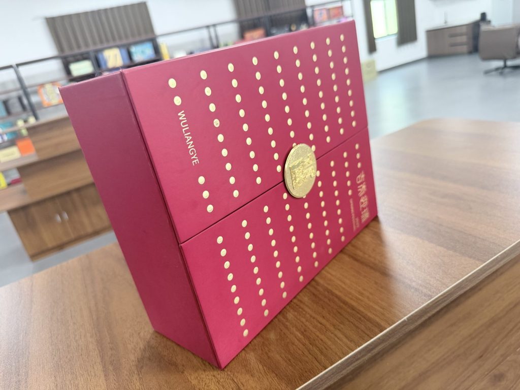 Elegant Maroon Gift Box With Gold Polka Dot Pattern And Circular Gold Clasp - view